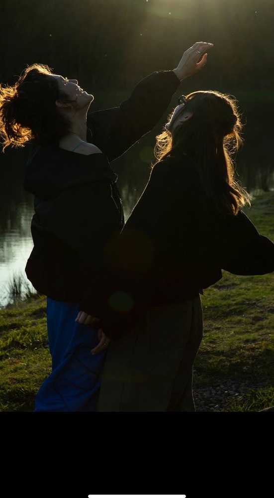 The two sisters beside the water in late-summer light
